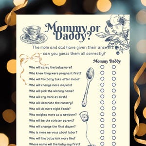 May include: A baby shower game card with the title "Mommy or Daddy?" features a floral design and a teacup illustration. The game includes questions about the parents and a space to guess the answers. The card is printed on cream-colored paper.