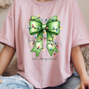 メリーグリンチシャツ、グリンチクリスマスTシャツ、ガーリークリスマスリボンスウェットシャツ、キッズグリンチTシャツ、クリスマスグリンチリボンシャツ