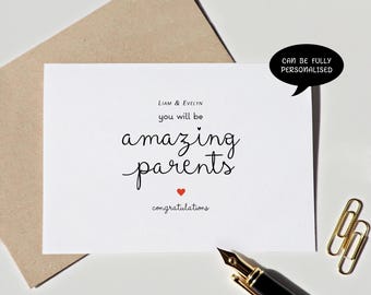 May include: A white greeting card with black text that reads Liam & Evelyn you will be amazing parents, featuring a small red heart and the word congratulations. A black speech bubble says CAN BE FULLY PERSONALISED, with a fountain pen and paper clips.