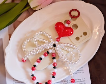 Gepersonaliseerde romantisch hart parel telefoonbedelbandje: elegant schouderbandje met strik en koord met dikke kralen