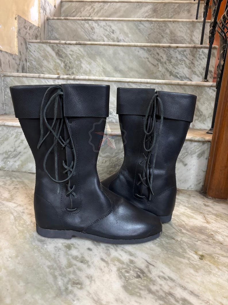 Detailed view of leather sole and quality construction of tall medieval boots.