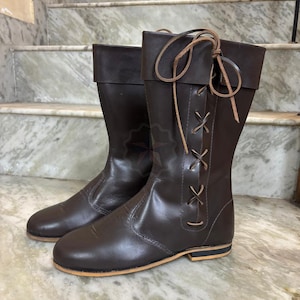 Tall handmade boots styled with medieval costume outfit for festival wear.