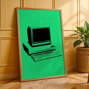 May include: A framed wall art print featuring a bright green background with a black graphic illustration of a vintage desktop computer system, including a monitor, a central processing unit, and a keyboard, all displayed in a simple wooden frame.