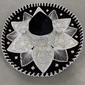 May include: A set of three ceramic vases in varying heights. The vases are white with a textured, ribbed design. The tallest vase is approximately 10 inches tall, the medium vase is 8 inches, and the smallest is 6 inches.