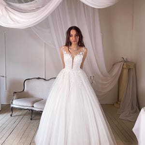 Elegant Wedding Dress adorned with embroidered floral lace.