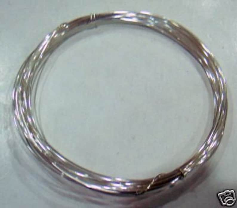May include: A coil of silver wire, perfect for jewelry making or crafting projects.