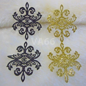 May include: Four decorative paper cutouts with a damask pattern. Two are gold glitter and two are black glitter.