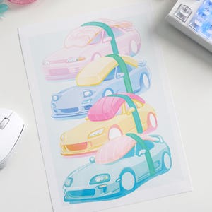 May include: A print featuring four stylized sports cars in pastel colors: pink, blue, yellow, and light blue. Each car is adorned with a colorful, abstract design. A green band connects the cars. The print is on a white background.