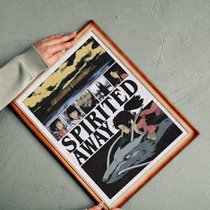 May include: Framed print featuring artwork from the animated film "Spirited Away." The print has a wooden frame and displays a collage of scenes, including a train and characters. The title "Spirited Away" is prominently displayed.