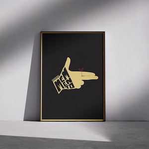 May include: Framed art print featuring a stylized hand gesture with the fingers forming a gun shape. The hand is gold against a black background, with the words "Memento" incorporated into the design. A red string is tied around the index finger.