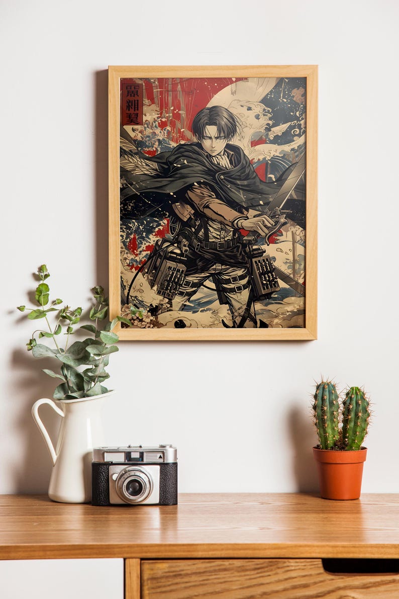 May include: Wooden framed print featuring a character from the anime series Attack on Titan. The artwork depicts a figure with a sword, set against a backdrop of red and white splashes. The print is displayed on a wooden surface.