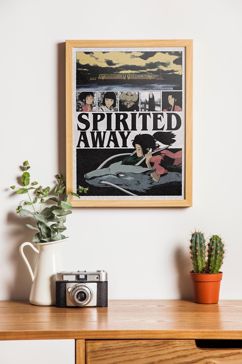 May include: A framed poster featuring the animated film "Spirited Away." The poster has a wooden frame and displays a scene with a girl riding a dragon-like creature. The title "Spirited Away" is prominently displayed.