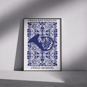 May include: A framed art print featuring a blue French horn silhouette over a blue and white floral pattern. The text at the top reads "I WOULD HAVE STOLEN YOU" and the text at the bottom reads "A WHOLE ORCHESTRA".