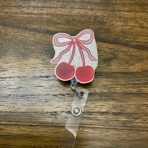 Red bow cherries badge reel