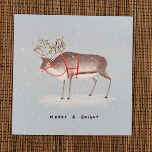 Carte de Noël de renne joyeux et lumineux