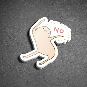 May include: A sticker of a cartoon figure with a light brown body and a pink face saying "NO" in a yellow speech bubble.