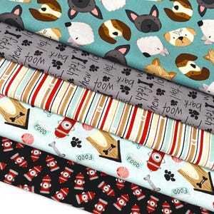 May include: Five different fabric swatches with dog-themed patterns. The top swatch is teal blue with a repeating pattern of dogs and cats. The second swatch is gray with the words "woof", "bark", "fetch", and "itch" repeated. The third swatch is a striped pattern of red, white, and brown. The fourth swatch is light blue with a repeating pattern of dog bones, dog food bowls, fire hydrants, and paw prints. The fifth swatch is black with a repeating pattern of red fire hydrants.