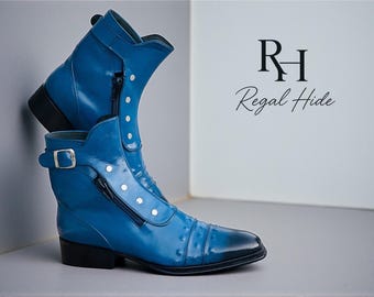 May include: Blue leather ankle boots with a glossy finish. The boots have a side zip, decorative buttons, and a buckle. The brand name "Regal Hide" is displayed. The boots are a stylish footwear option.
