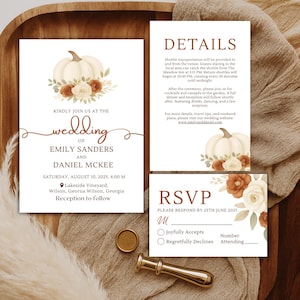 May include: Wedding invitation suite featuring a white pumpkin and floral design. The invitation includes details for Emily Sanders and Daniel McKee's wedding on August 10, 2025. Includes RSVP and details cards.