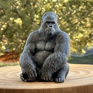 May include: A set of three ceramic mugs with a speckled, cream-colored glaze. Each mug features a different hand-painted floral design in shades of blue, green, and yellow. The mugs have a simple, rounded shape and a comfortable handle.