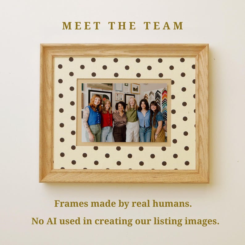 May include: A light oak wood picture frame containing a photograph of six people standing together. The frame features a cream-colored mat with a brown polka dot pattern. Text above the frame reads MEET THE TEAM, and below reads Frames made by real humans. No AI used in creating our listing images.