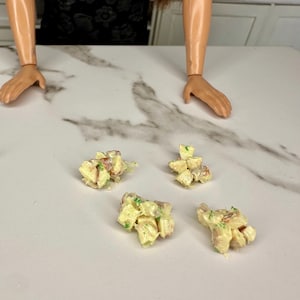 May include: A set of three ceramic mugs with a speckled, matte finish. Each mug features a different color: light blue, cream, and gray. The mugs have a simple, modern design and a comfortable handle.