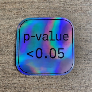 May include: Holographic sticker with rounded corners. The sticker has a colourful, iridescent design with the text "p-value < 0.05" in black. The sticker is likely used for scientific or academic purposes.