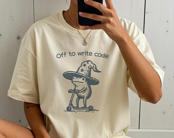 コードを書き始めるホバーボードに乗った魔女のカエル プログラマー 開発者 オタク T シャツ