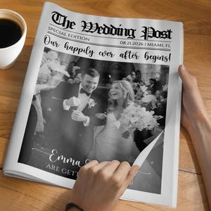 May include: A newspaper titled "The Wedding Post" with a black and white wedding photo. The headline reads "Our happily ever after begins!" and the date is 08.21.2026. A cup of coffee sits on a wooden surface.