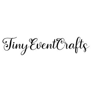 May include: The words "Tiny Event Crafts" are written in elegant, cursive black script on a white background. The text is centered, with the letters flowing together in a decorative style, suggesting a focus on small-scale event decorations and crafts.