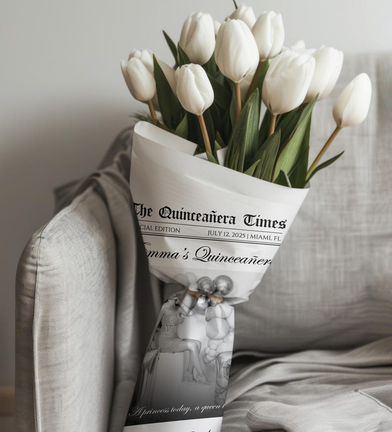 May include: A bouquet of white tulips wrapped in newspaper-style paper. The paper is printed with "The Quincea&ntilde;era Times" and "July 12, 2025 | Miami, FL". The bouquet is tied with a decorative ribbon.