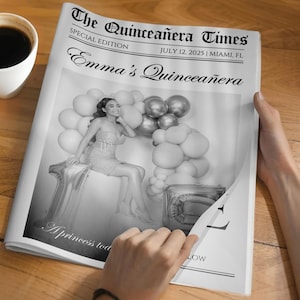 May include: A black and white newspaper titled "The Quincea&ntilde;era Times" with the headline "Emma's Quincea&ntilde;era." The special edition newspaper includes a photo of a woman with balloons. A cup of coffee sits on the wooden surface.