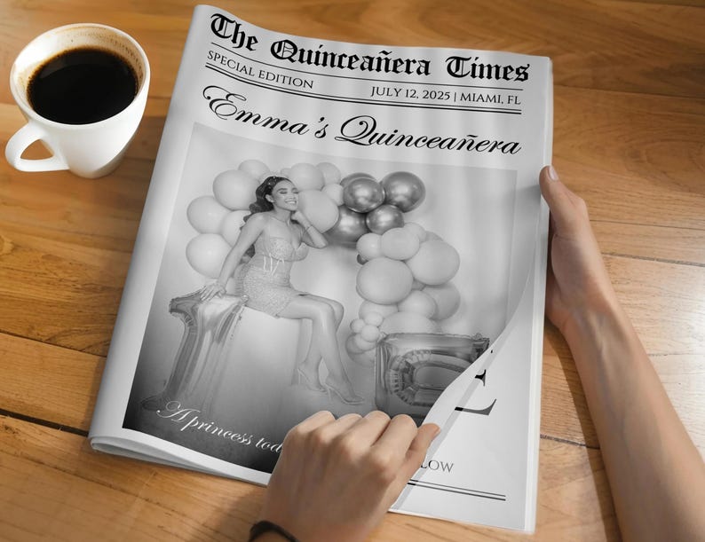 May include: A black and white newspaper titled "The Quincea&ntilde;era Times" with the headline "Emma's Quincea&ntilde;era." The special edition newspaper includes a photo of a woman with balloons. A cup of coffee sits on the wooden surface.