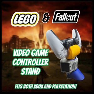 May include: A video game controller stand with a white and black controller. The stand is yellow, blue, and grey. The image includes the text "LEGO & Fallout" and "VIDEO GAME CONTROLLER STAND FITS BOTH XBOX AND PLAYSTATION!"