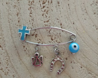 Blue cross brooch with good luck charms