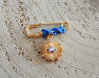 Sparkling evil eye with spikes blue brooch