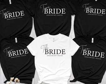 May include: A collection of black and white t-shirts. The black shirts read "Team Bride" in a script font, with "Sophie's Hen Party - Wales 2023" below. One white shirt says "The Bride" in a script font, with the same text below.