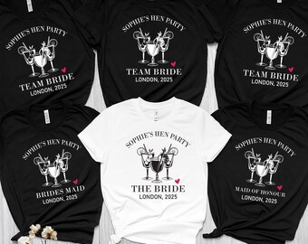 May include: A collection of black and white t-shirts with the text "SOPHIE'S HEN PARTY" and various roles like "TEAM BRIDE", "BRIDES MAID", "THE BRIDE", and "MAID OF HONOUR". Each shirt features a cocktail graphic and the location "LONDON, 2025".