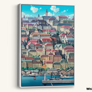 May include: A framed canvas print featuring a vibrant illustration of a European coastal town. The artwork showcases colorful buildings with red-tiled roofs, a harbor with boats, and a bright blue sky with fluffy clouds. The canvas is framed in white.