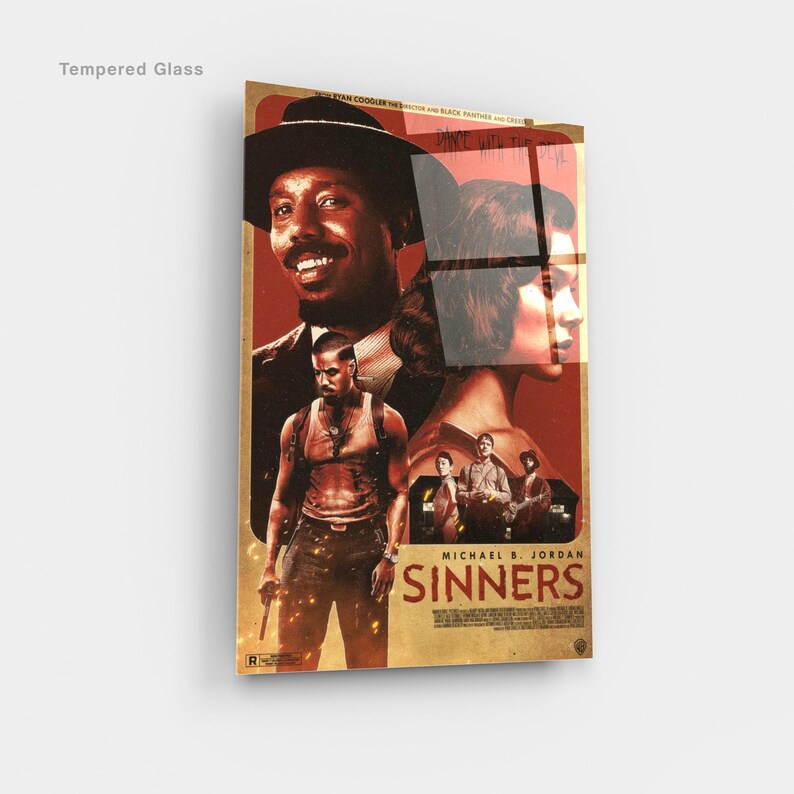 May include: A framed movie poster for "Sinners" featuring Michael B. Jordan. The poster has a vintage aesthetic with a red and brown color scheme. The title "Sinners" is prominently displayed.