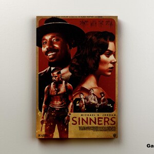 May include: A rectangular canvas print featuring a movie poster with the title "Sinners." The poster showcases three figures, with Michael B. Jordan's name prominently displayed. The color palette is dominated by red and brown tones.