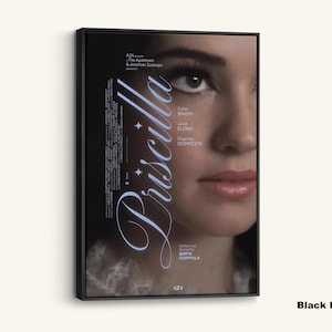 May include: Black framed canvas art featuring a close-up of a woman's face, with the title "Priscilla" in elegant script. The poster includes the names of the cast and director, Sofia Coppola. The background is dark, with the woman's face in focus.