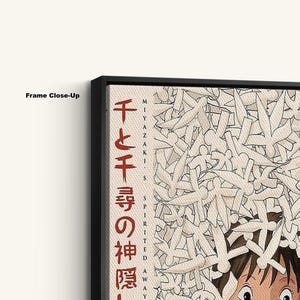 May include: Close-up of a framed print featuring Japanese text and artwork. The print has a black frame and displays a beige background with white and black illustrations. The Japanese text is in red and black.