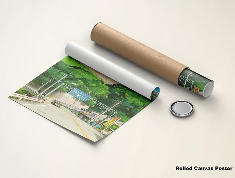 May include: A rolled canvas poster featuring a scenic highway view with lush green trees and a blue road sign. The poster is partially unrolled, with a white tube and a brown cardboard tube next to it. A silver cap is also present.