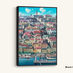 May include: A framed canvas print featuring a vibrant illustration of a coastal town. The artwork showcases colorful buildings with red, brown, and green roofs, a harbor with boats, and a bright blue sky with fluffy clouds. The text "Black Framed Canvas" is at the bottom.