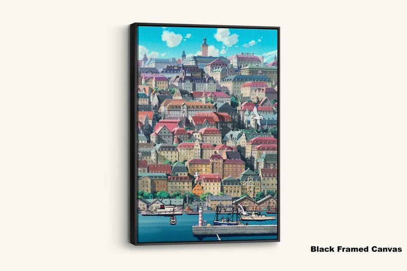 May include: A framed canvas print featuring a vibrant illustration of a coastal town. The artwork showcases colorful buildings with red, brown, and green roofs, a harbor with boats, and a bright blue sky with fluffy clouds. The text "Black Framed Canvas" is at the bottom.