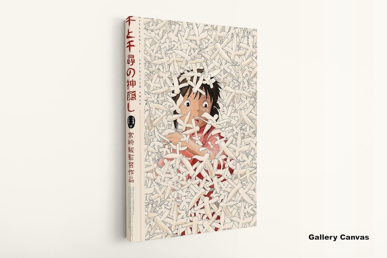May include: A canvas print of the animated film "Spirited Away." The artwork features a central image of a character surrounded by white figures. Japanese text is visible on the side of the canvas.