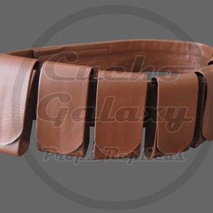 May include: A brown leather belt with multiple pouches. The belt is a medium brown color and features several rectangular pouches evenly spaced around its circumference. The belt is designed to be worn around the waist.