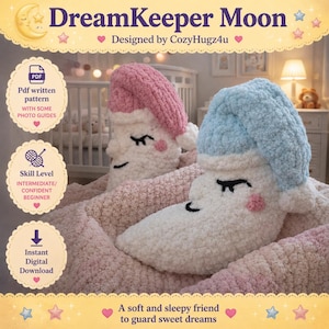 May include: Two plush moon-shaped pillows, one with a pink cap and the other with a blue cap, rest on a pink blanket. The pillows have closed eyes, rosy cheeks, and black eyelashes. The text "DreamKeeper Moon" and "Designed by CozyHugz4u" are visible.