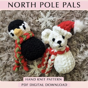 May include: Two crocheted plush toys labeled NORTH POLE PALS, HAND KNIT PATTERN, PDF DIGITAL DOWNLOAD. One is a black and white penguin with a red and green scarf, the other is a white bear with a red Santa hat and a red and white scarf.